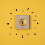 micro puzzles pieces magnified by window on box