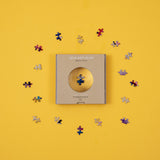 micro puzzles pieces magnified by window on box