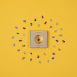 micro puzzle pieces magnified by window on box