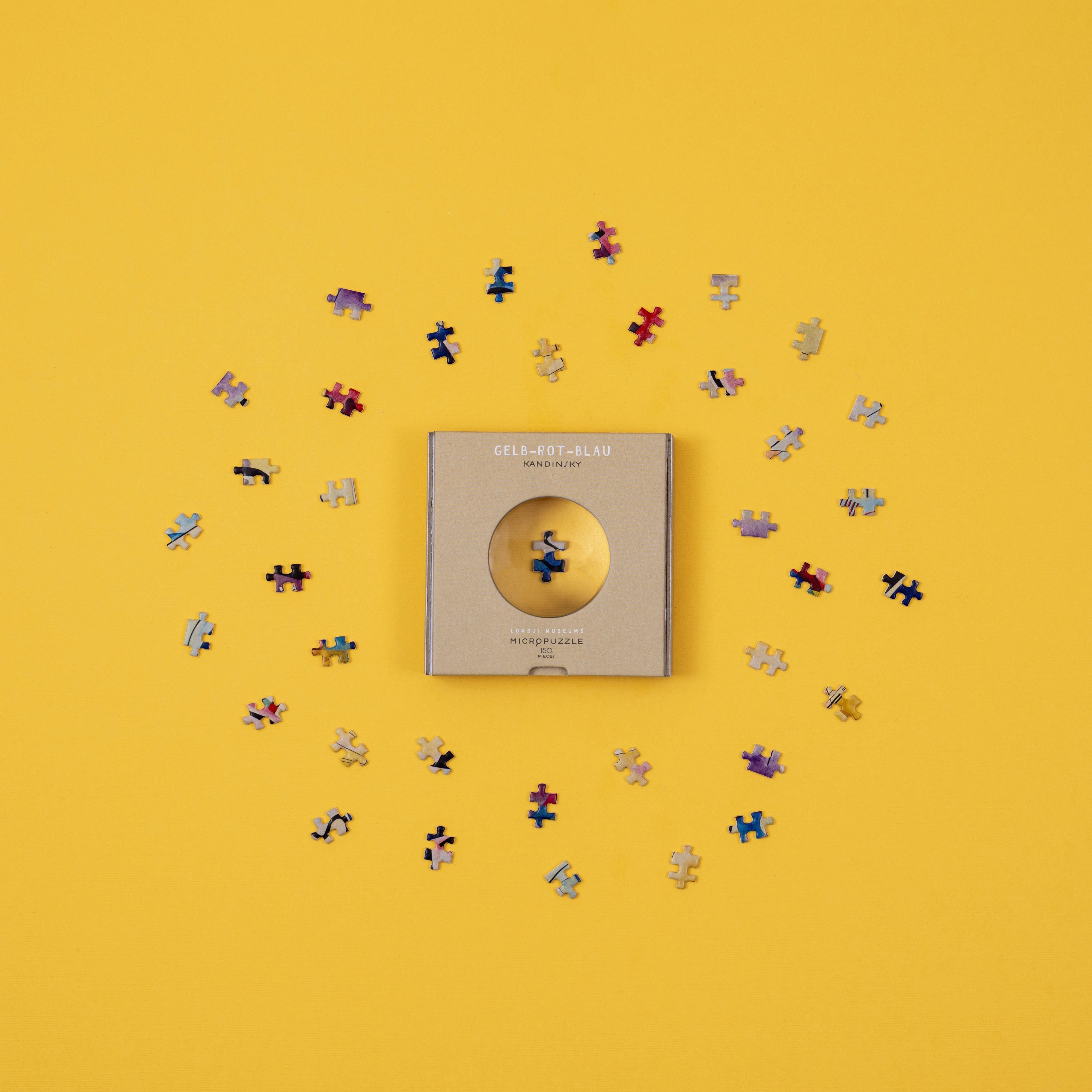 micro puzzle pieces magnified by window on box