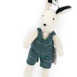 White plush keychain with a black nose, wearing a green outfit on a white background